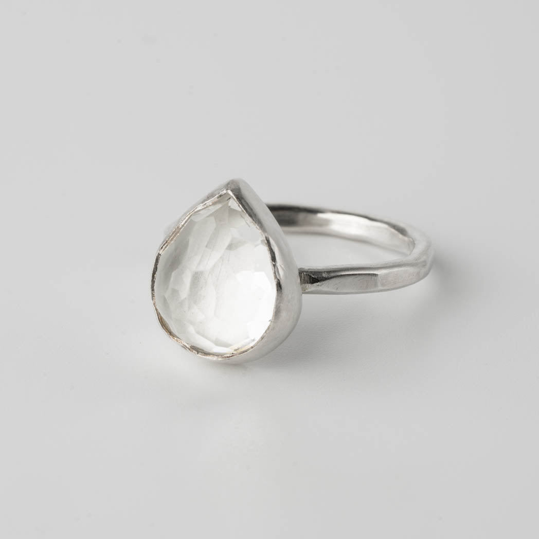 Cocktailring i äkta silver med en vit topas i droppform och rosenslipning, handgjord och elegant, fotograferad mot vit bakgrund.